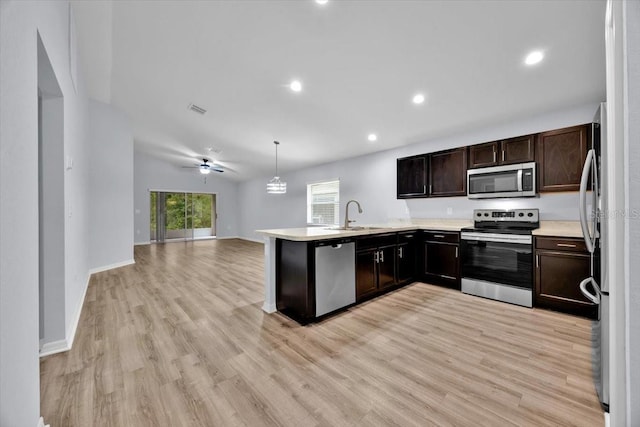 907 Pearly Ridge Ln, Lakeland, FL 33809 - kitchen featuring appliances with stainless steel finishes, a peninsula, light wood finished floors, light countertops, and recessed lighting