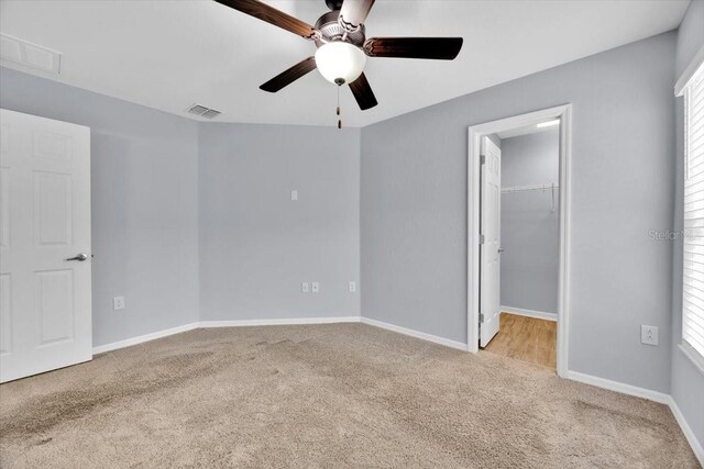 907 Pearly Ridge Ln, Lakeland, FL 33809 - unfurnished bedroom with carpet flooring, a spacious closet, baseboards, a ceiling fan, and a closet