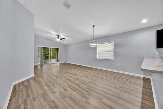 907 Pearly Ridge Ln, Lakeland, FL 33809 - unfurnished living room with light wood-style flooring, baseboards, a ceiling fan, vaulted ceiling, and recessed lighting