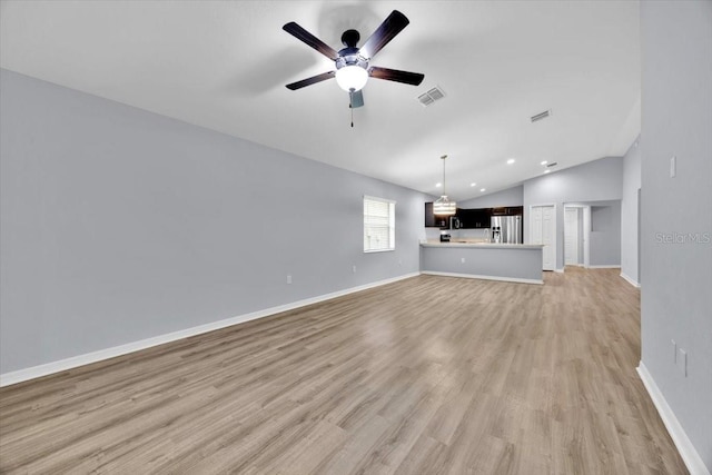 907 Pearly Ridge Ln, Lakeland, FL 33809 - unfurnished living room with lofted ceiling, light wood-style floors, ceiling fan, baseboards, and recessed lighting
