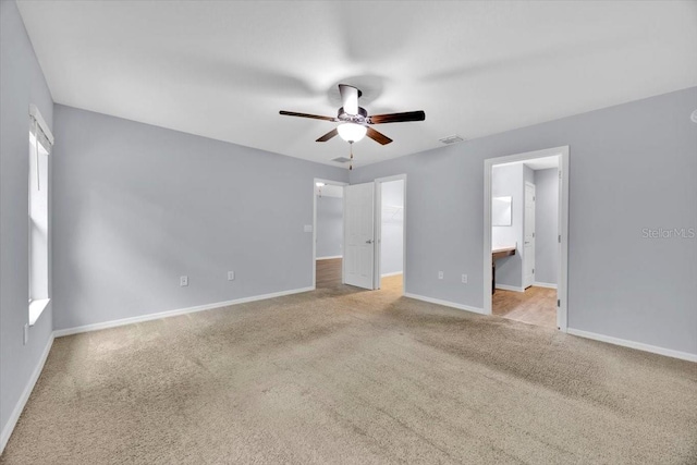 907 Pearly Ridge Ln, Lakeland, FL 33809 - unfurnished bedroom with carpet flooring, a walk in closet, baseboards, ensuite bathroom, and a ceiling fan