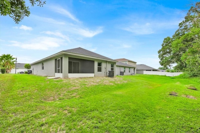 907 Pearly Ridge Ln, Lakeland, FL 33809 - rear view of property featuring central air condition unit, stucco siding, and a sunroom