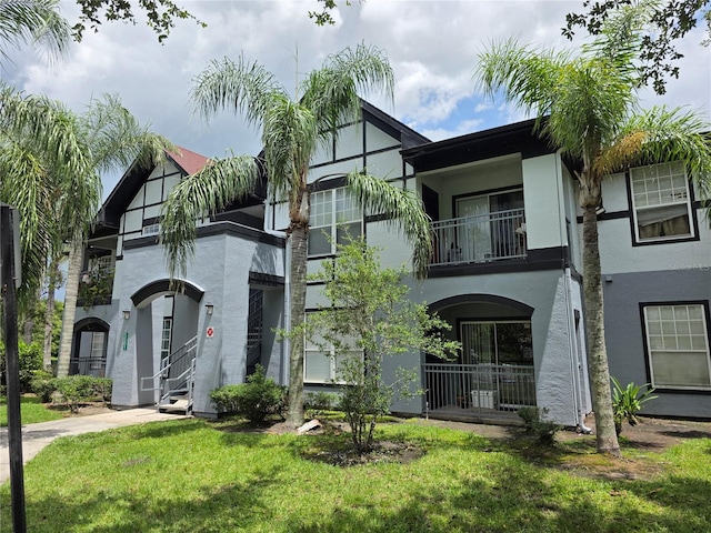 5501 Pga Blvd Unit 4723, Orlando, FL 32839 - view of front of home with a balcony, stucco siding, and a front yard