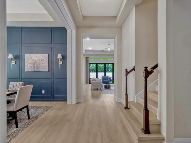 8047 Chilton Dr, Orlando, FL 32836 - foyer featuring light wood-style flooring, baseboards, a ceiling fan, and stairs
