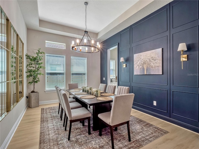 8047 Chilton Dr, Orlando, FL 32836 - dining area with a chandelier, light wood-style floors, and baseboards
