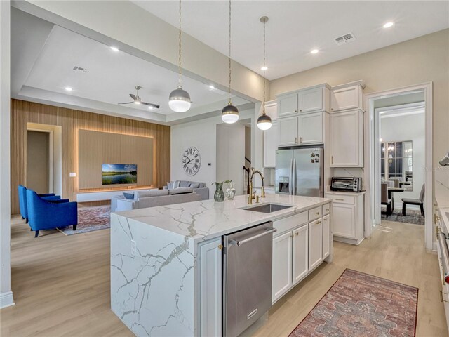 8047 Chilton Dr, Orlando, FL 32836 - kitchen with stainless steel appliances, a sink, light wood-style floors, white cabinetry, and recessed lighting