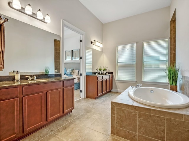 8047 Chilton Dr, Orlando, FL 32836 - bathroom with a bath, two vanities, and tile patterned floors