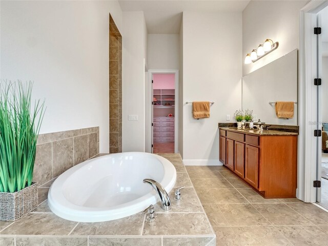 8047 Chilton Dr, Orlando, FL 32836 - bathroom featuring vanity, a bath, and a walk in closet