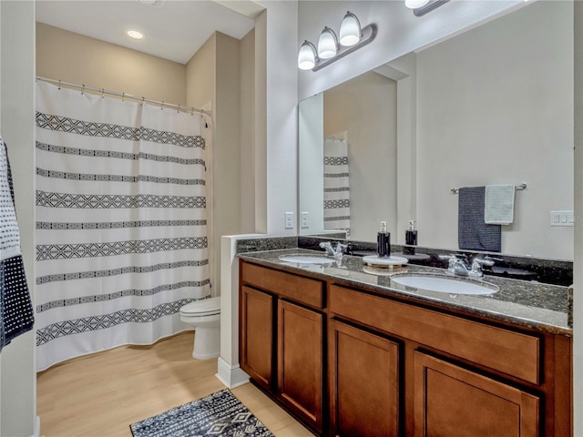 8047 Chilton Dr, Orlando, FL 32836 - full bath with double vanity, toilet, wood finished floors, and curtained shower