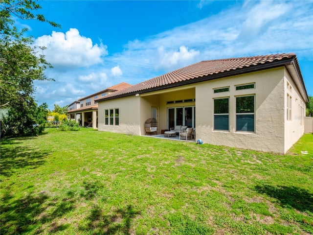 8047 Chilton Dr, Orlando, FL 32836 - back of house featuring stucco siding, a lawn, and a tiled roof