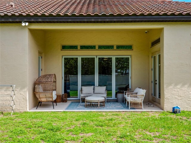 8047 Chilton Dr, Orlando, FL 32836 - rear view of property featuring stucco siding, a lawn, a patio area, and a tiled roof