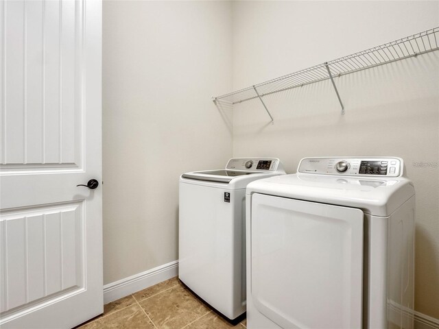 8047 Chilton Dr, Orlando, FL 32836 - washroom with washer and dryer, baseboards, and light tile patterned floors