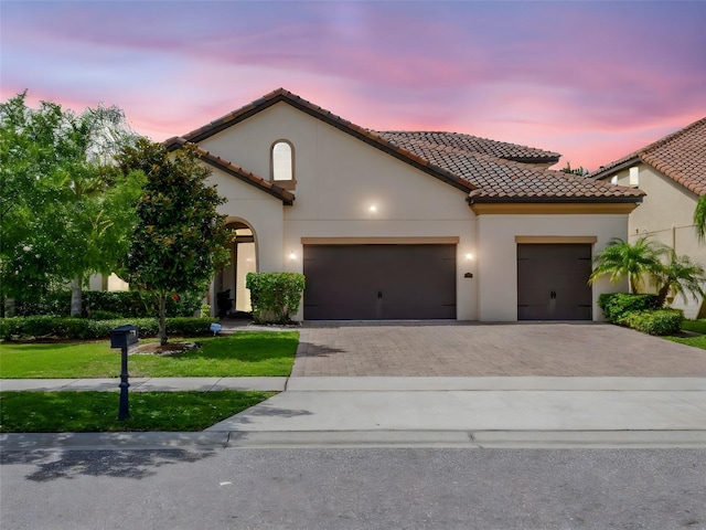 8047 Chilton Dr, Orlando, FL 32836 - mediterranean / spanish house with a garage, decorative driveway, a tile roof, and a front lawn