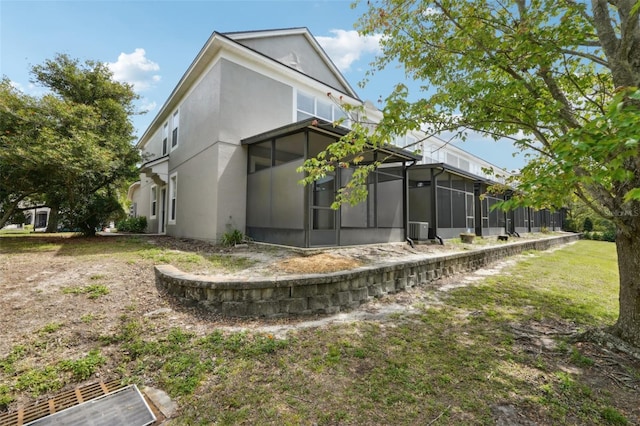 10124 Westpark Preserve Blvd, Tampa, FL 33625 - back of house with a sunroom, stucco siding, and central AC unit