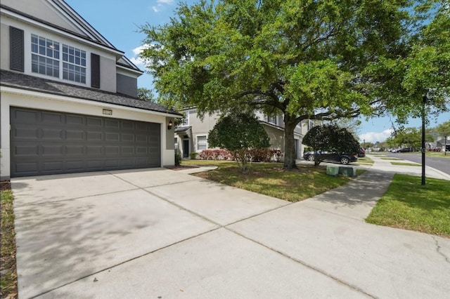 10124 Westpark Preserve Blvd, Tampa, FL 33625 - view of front facade with stucco siding, a garage, and driveway