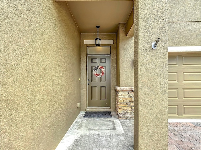 view of exterior entry with stucco siding