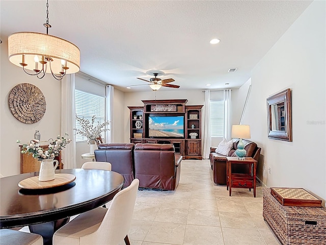 living area featuring a ceiling fan, light tile patterned flooring, a chandelier, recessed lighting, and a textured ceiling