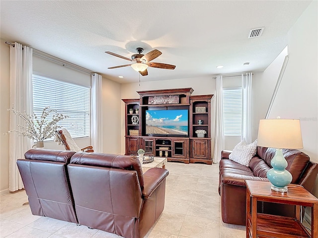 living room featuring a ceiling fan, light tile patterned flooring, and recessed lighting