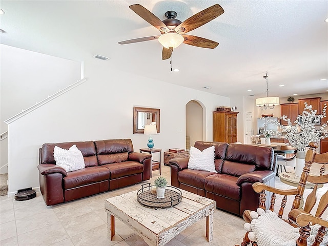 living room with arched walkways, a ceiling fan, recessed lighting, and light tile patterned floors