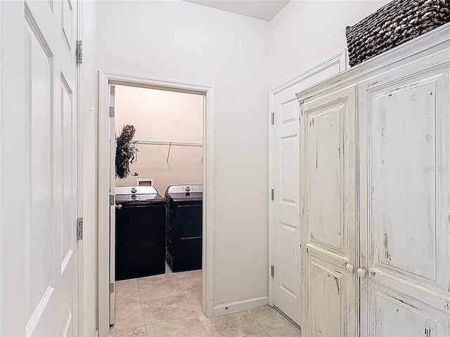 laundry area featuring washing machine and dryer and baseboards