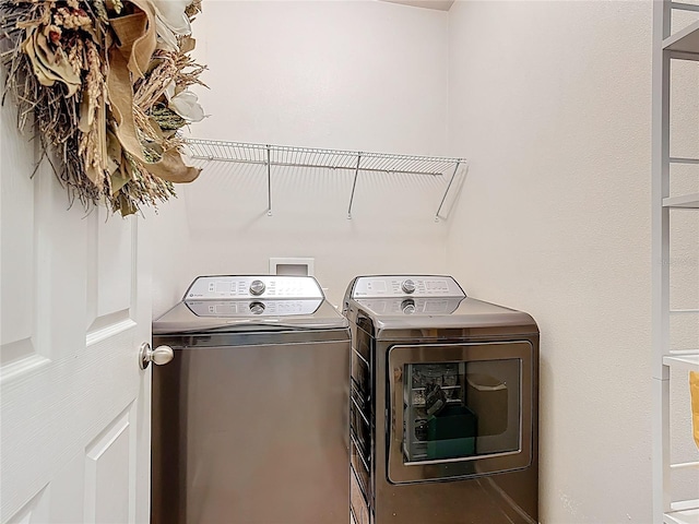 laundry area with washing machine and dryer