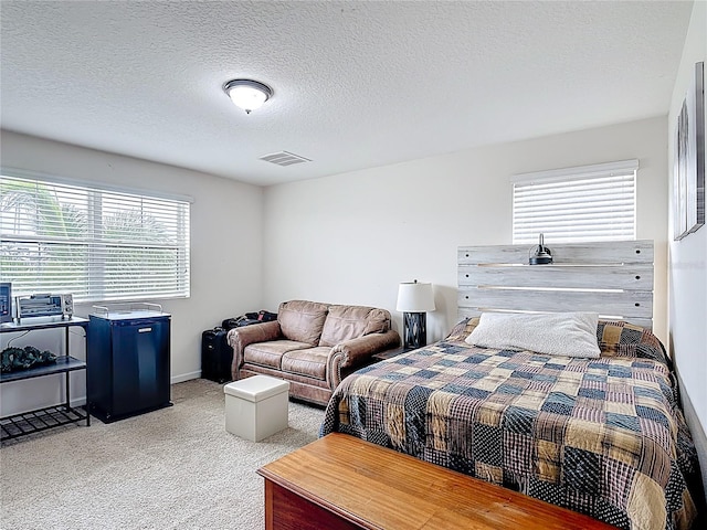 bedroom featuring carpet flooring and a textured ceiling
