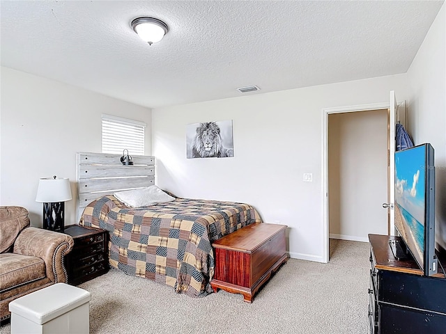 bedroom featuring carpet flooring, a textured ceiling, and baseboards