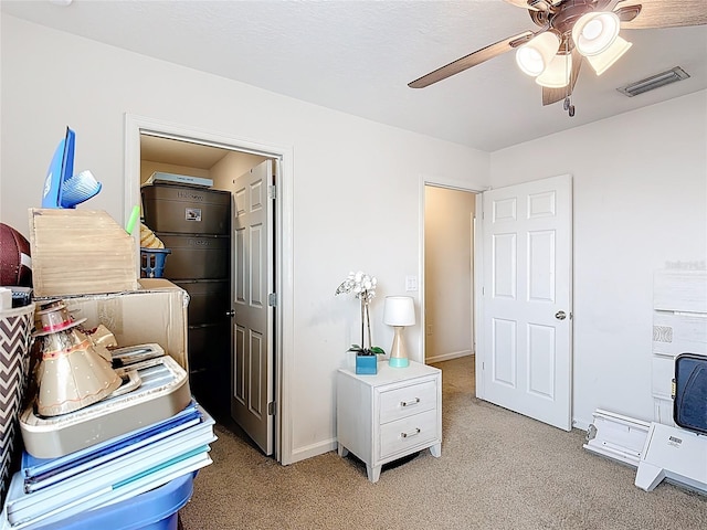 bedroom featuring light colored carpet, ceiling fan, and baseboards