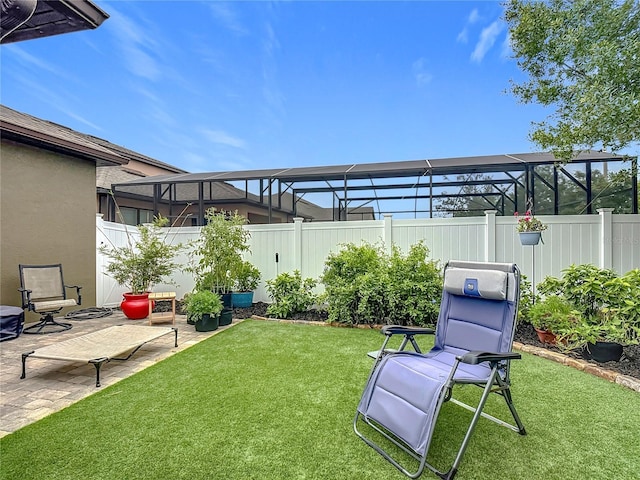 view of yard featuring a patio area and glass enclosure