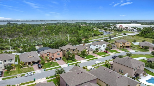 aerial perspective of suburban area with a nearby body of water