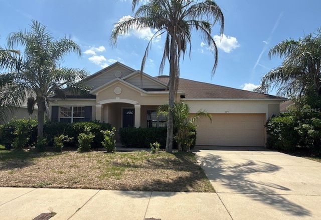 579 Setting Sun Dr, Winter Garden, FL 34787 - view of front of house with an attached garage, driveway, and stucco siding