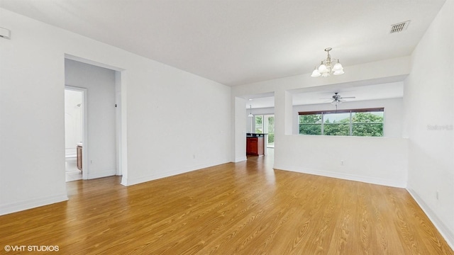 579 Setting Sun Dr, Winter Garden, FL 34787 - empty room featuring a chandelier, light wood-style flooring, and baseboards