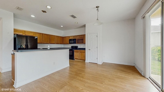 579 Setting Sun Dr, Winter Garden, FL 34787 - kitchen with black appliances, healthy amount of natural light, dark countertops, light wood-type flooring, and recessed lighting