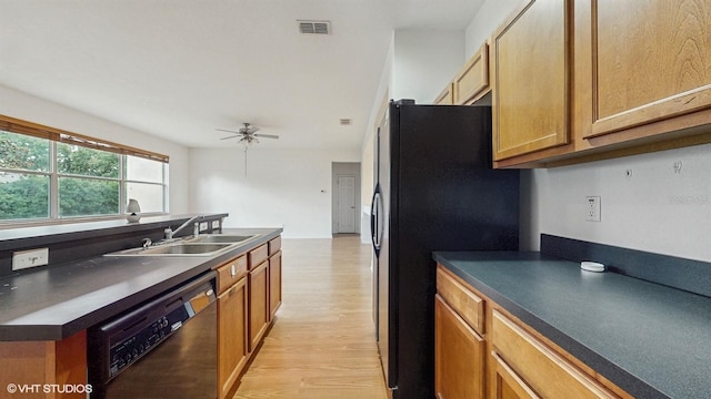 579 Setting Sun Dr, Winter Garden, FL 34787 - kitchen with dishwasher, black fridge with ice dispenser, light wood-type flooring, a sink, and dark countertops