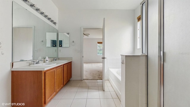 579 Setting Sun Dr, Winter Garden, FL 34787 - bathroom with a garden tub, tile patterned floors, double vanity, and a ceiling fan