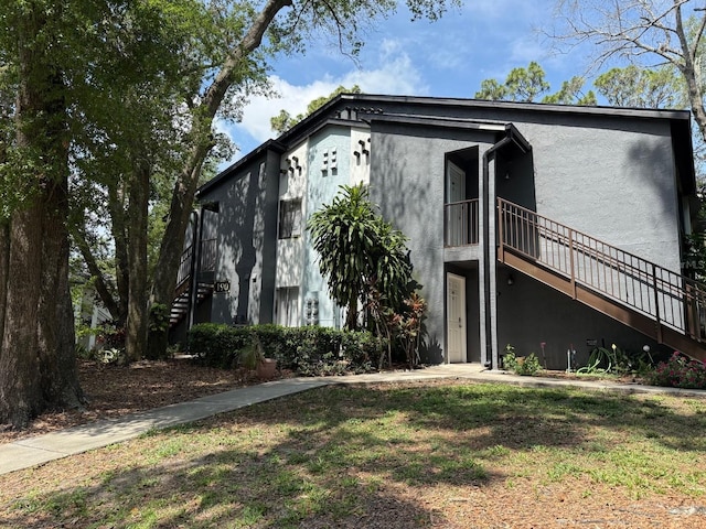 190 Riverbend Dr Unit 102, Altamonte Springs, FL 32714 - view of front facade featuring stucco siding and stairway
