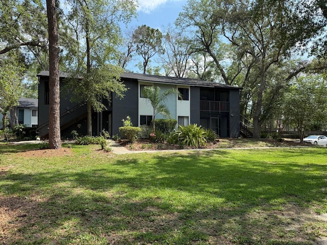 190 Riverbend Dr Unit 102, Altamonte Springs, FL 32714 - view of front of home with stairway, stucco siding, and a front yard