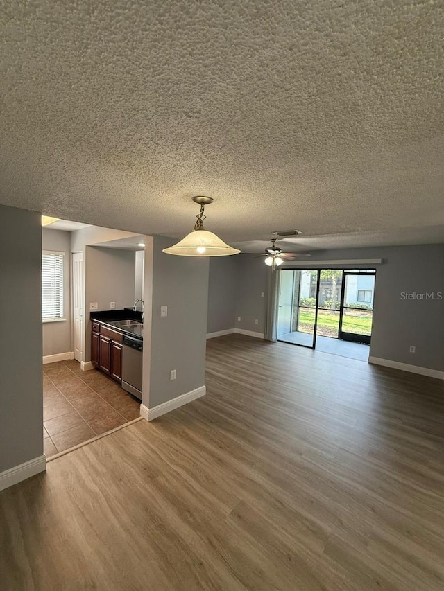190 Riverbend Dr Unit 102, Altamonte Springs, FL 32714 - unfurnished living room with dark wood finished floors, a ceiling fan, baseboards, and a textured ceiling