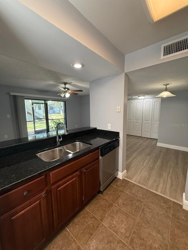190 Riverbend Dr Unit 102, Altamonte Springs, FL 32714 - kitchen featuring stainless steel dishwasher, a sink, dark tile patterned floors, baseboards, and ceiling fan