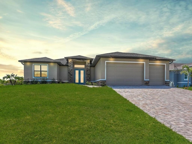 9257 King Hill St, Port Charlotte, FL 33981 - prairie-style house with stucco siding, a garage, decorative driveway, and stone siding