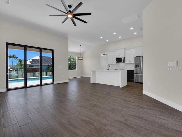9257 King Hill St, Port Charlotte, FL 33981 - unfurnished living room featuring ceiling fan, dark wood-type flooring, and recessed lighting