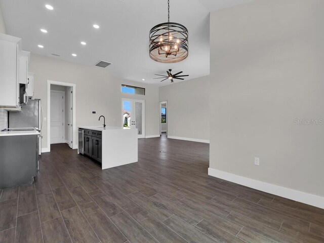 9257 King Hill St, Port Charlotte, FL 33981 - kitchen with a chandelier, light countertops, dark wood-type flooring, white cabinetry, and recessed lighting