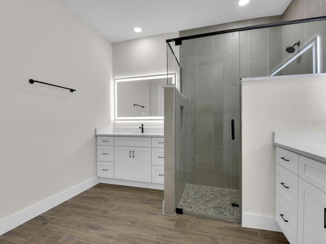 9257 King Hill St, Port Charlotte, FL 33981 - bathroom featuring vanity, a stall shower, recessed lighting, and wood finished floors