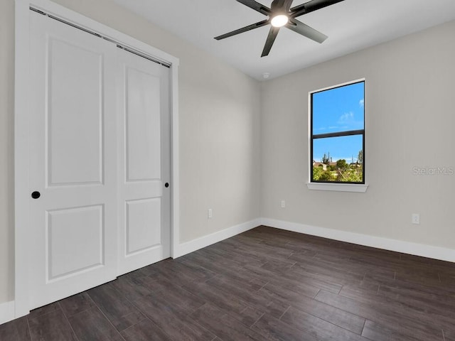 9257 King Hill St, Port Charlotte, FL 33981 - unfurnished bedroom with dark wood-type flooring, a closet, and a ceiling fan
