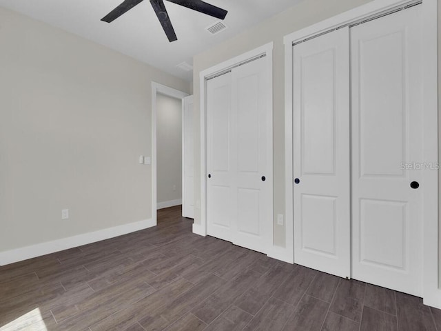 9257 King Hill St, Port Charlotte, FL 33981 - unfurnished bedroom with dark wood-type flooring, ceiling fan, and multiple closets