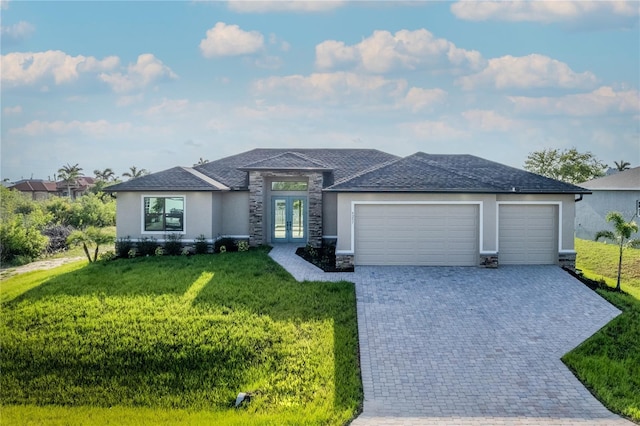 9257 King Hill St, Port Charlotte, FL 33981 - view of front of house featuring french doors, stucco siding, an attached garage, stone siding, and decorative driveway