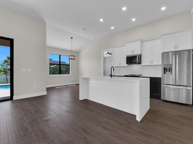 9257 King Hill St, Port Charlotte, FL 33981 - kitchen featuring stainless steel appliances, tasteful backsplash, a kitchen island with sink, white cabinets, and light countertops