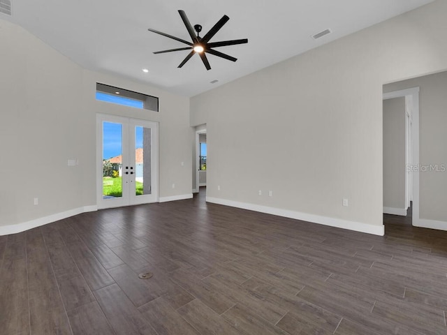 9257 King Hill St, Port Charlotte, FL 33981 - unfurnished living room featuring dark wood-type flooring, french doors, ceiling fan, recessed lighting, and a towering ceiling