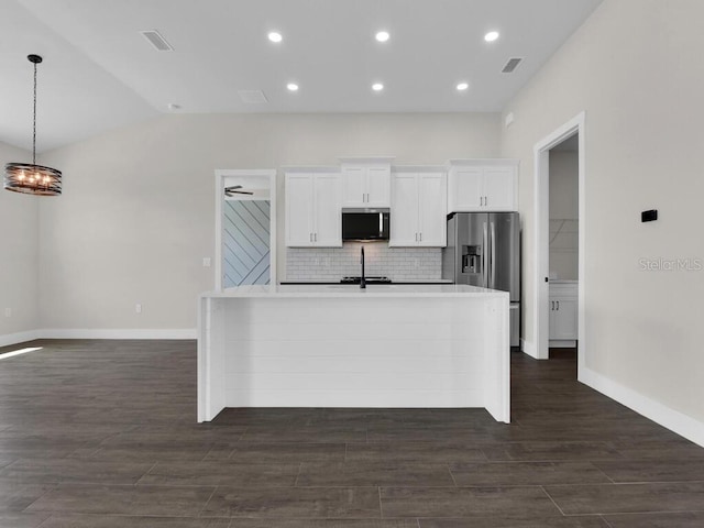 9257 King Hill St, Port Charlotte, FL 33981 - kitchen with stainless steel appliances, an island with sink, white cabinets, backsplash, and dark wood finished floors