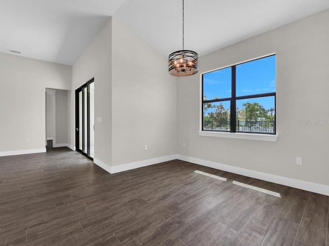 9257 King Hill St, Port Charlotte, FL 33981 - empty room with a chandelier and dark wood finished floors